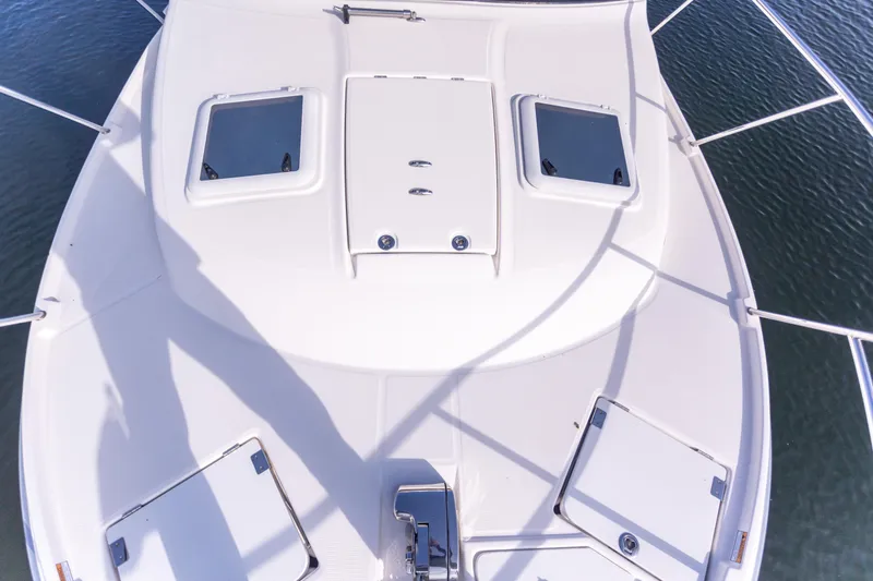 Slide: The Image of 2021 Cutwater C-32 CB boat deck with hatches and railing, viewed from above. - 48