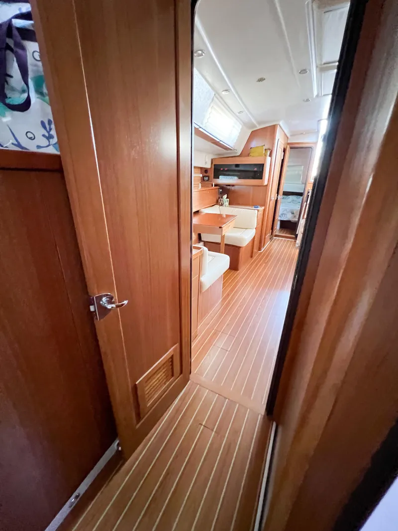 Slide: The Image of Interior of 2019 Catalina 425 yacht with wooden flooring and cozy seating area. - 18