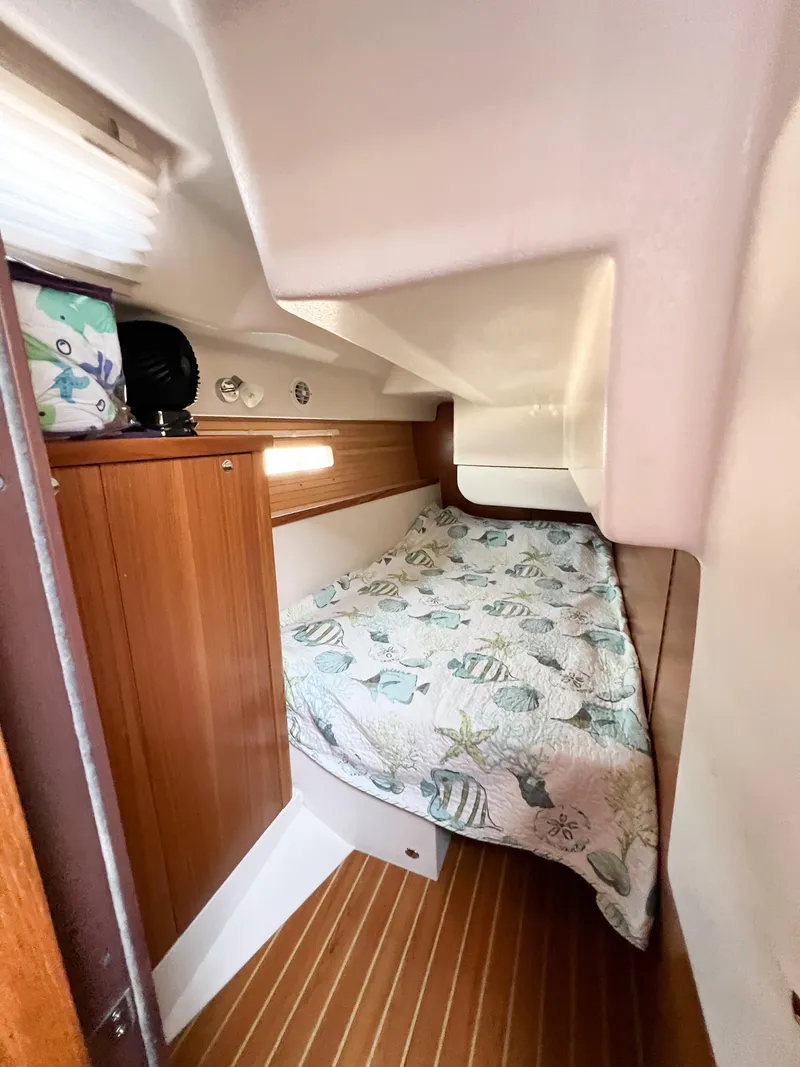 Slide: The Image of Cozy cabin interior of 2019 Catalina 425 sailboat with nautical-themed bedding. - 20