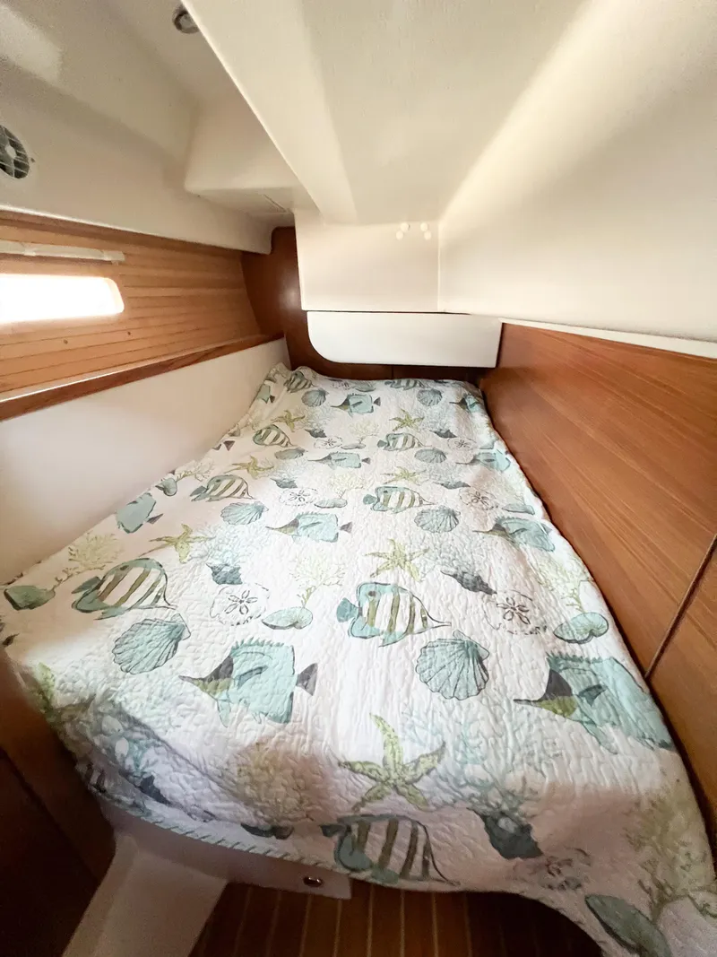 Slide: The Image of Cozy cabin interior of 2019 Catalina 425 sailboat with patterned bedding. - 21