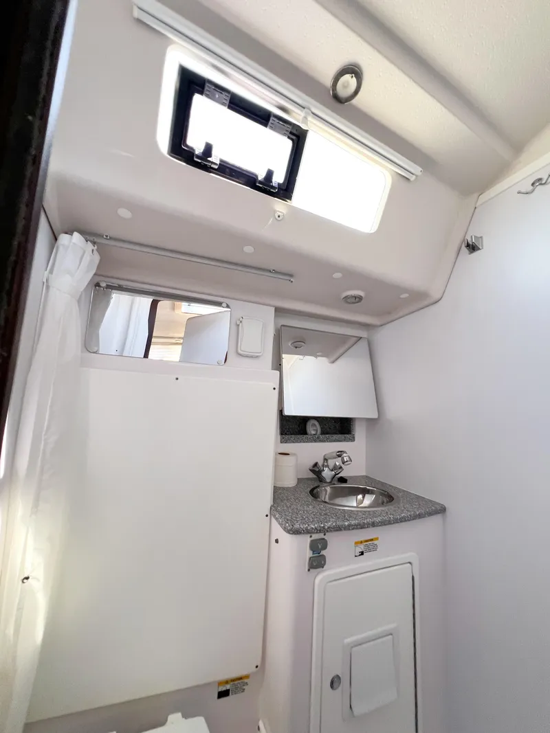Slide: The Image of 2019 Catalina 425 yacht bathroom with sink, mirror, and window. - 23
