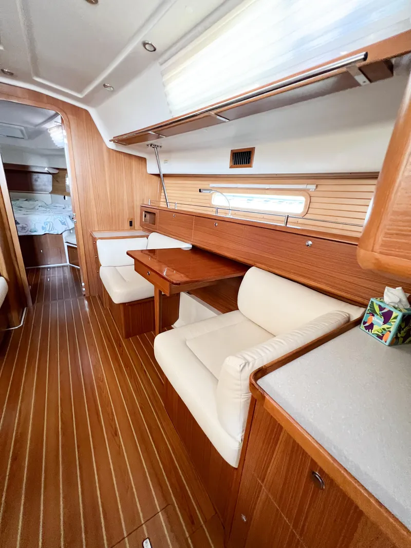 Slide: The Image of 2019 Catalina 425 yacht interior with wooden flooring and cozy seating area. - 24