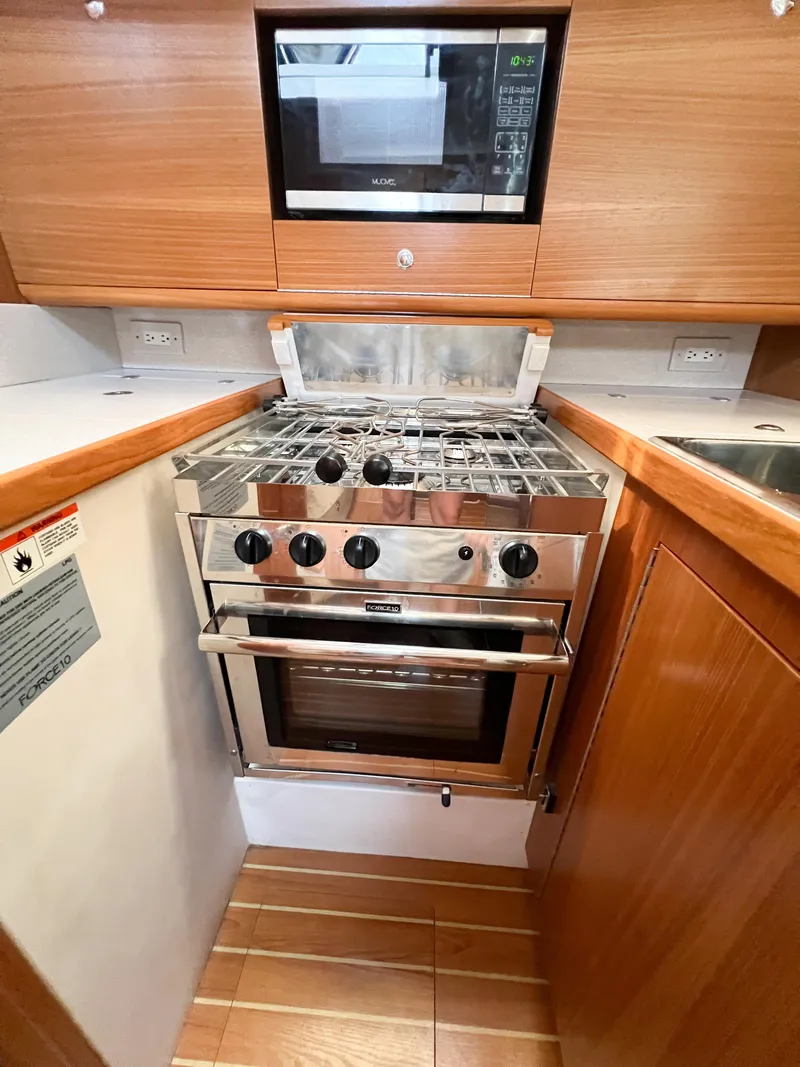 Slide: The Image of Galley kitchen in 2019 Catalina 425 yacht with stove and microwave. - 26