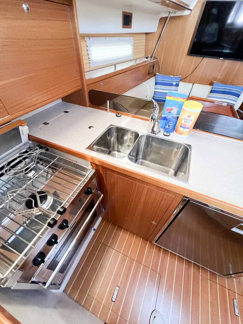 Slide: The Image of Modern kitchen in 2019 Catalina 425 yacht with dual sinks and stainless steel stove. - 27