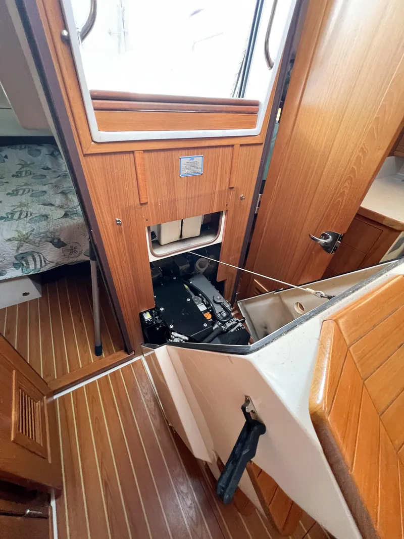 Slide: The Image of 2019 Catalina 425 interior with wood finish and open storage compartment. - 29