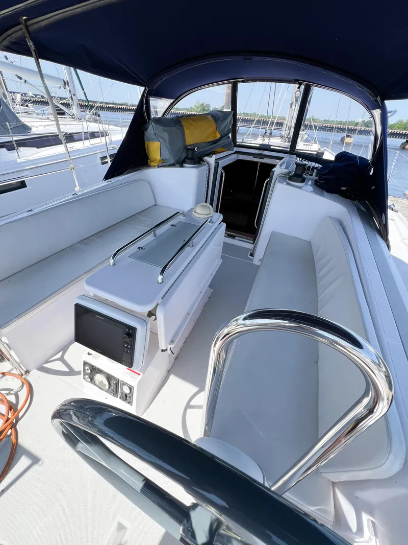 Slide: The Image of 2019 Catalina 425 yacht cockpit with seating, navigation equipment, and canopy. - 3