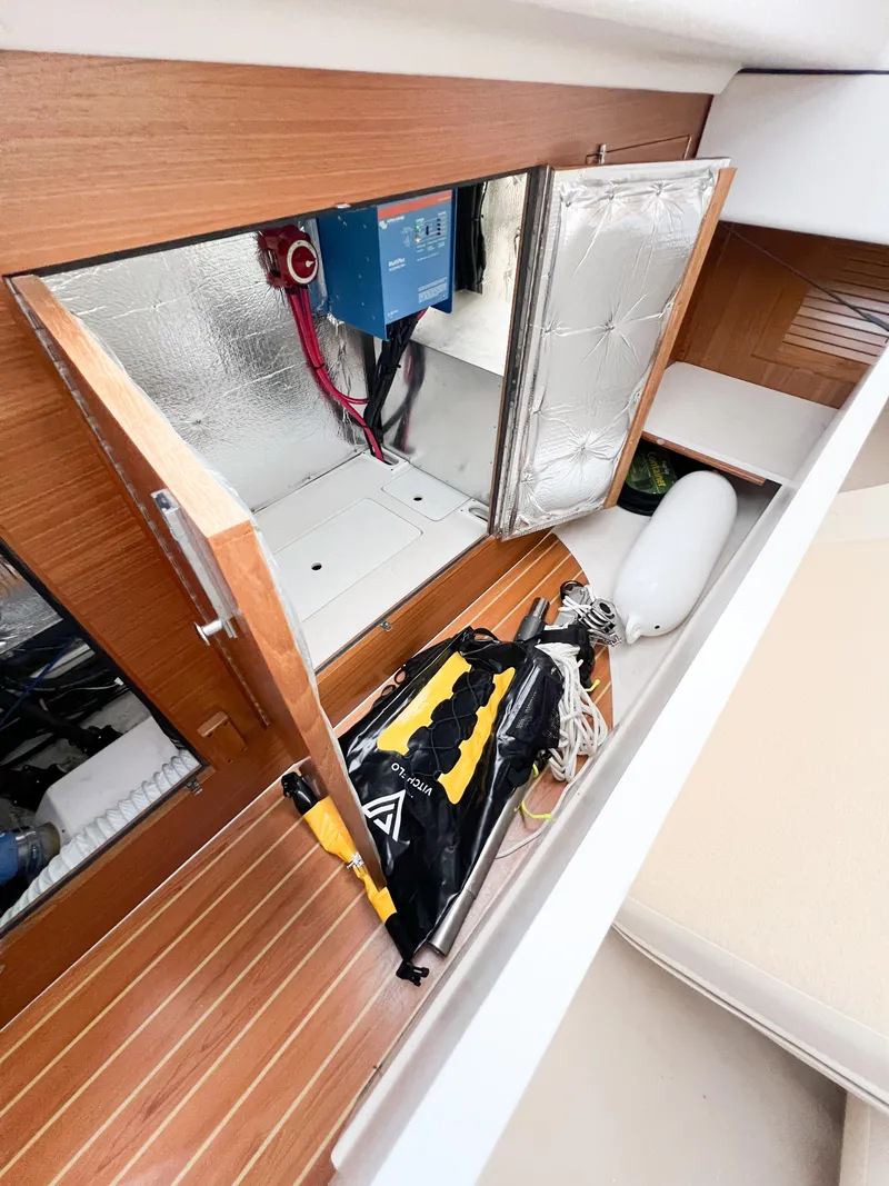 Slide: The Image of Interior view of a 2019 Catalina 425 sailboat, showcasing storage and electrical components. - 33