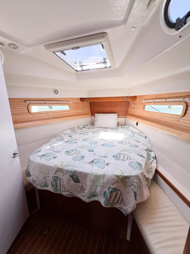 Slide: The Image of Cozy cabin interior of 2019 Catalina 425 sailboat with skylight and nautical bedding. - 37