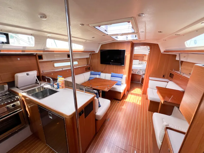 Slide: The Image of Luxurious 2019 Catalina 425 yacht interior with modern kitchen, cozy seating, and elegant wood finishes. - 40