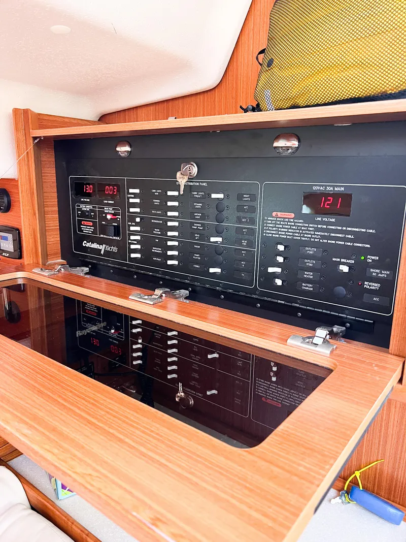 Slide: The Image of Electrical control panel inside a 2019 Catalina 425 yacht, featuring various switches and displays. - 45
