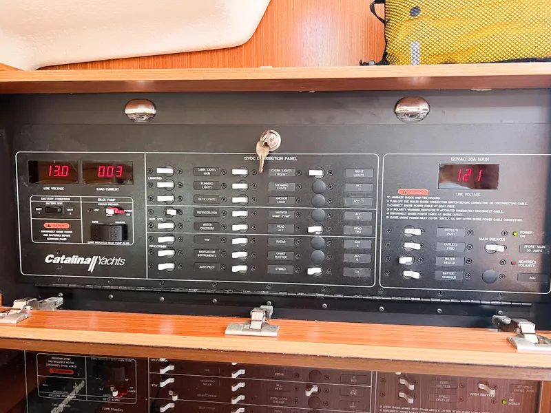 Slide: The Image of Electrical control panel of a 2019 Catalina 425 yacht, featuring various switches and displays. - 47