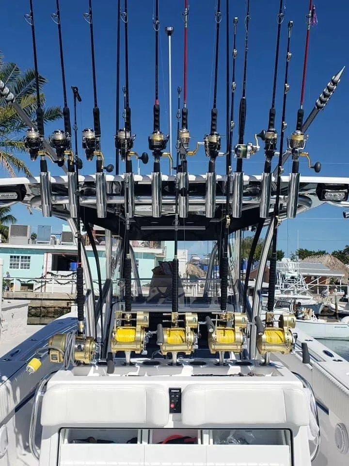 Slide: The Image of 2018 SeaHunter 39 Tournament boat with multiple fishing rods and reels, docked under clear blue sky. - 4