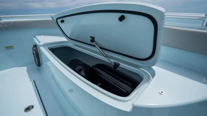 Slide: The Image of 2024 Contender 24 Sport boat storage compartment open, showcasing interior space. - 10
