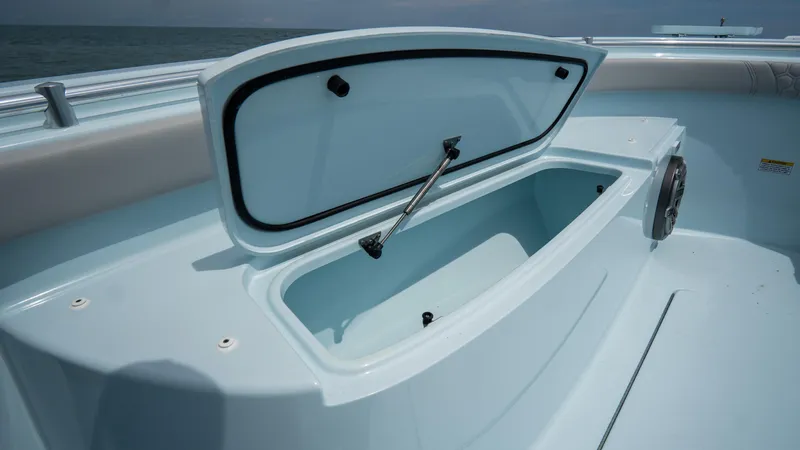 Slide: The Image of 2024 Contender 24 Sport boat storage compartment open on deck. - 11