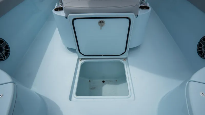 Slide: The Image of 2024 Contender 24 Sport boat storage compartment with open hatch. - 13