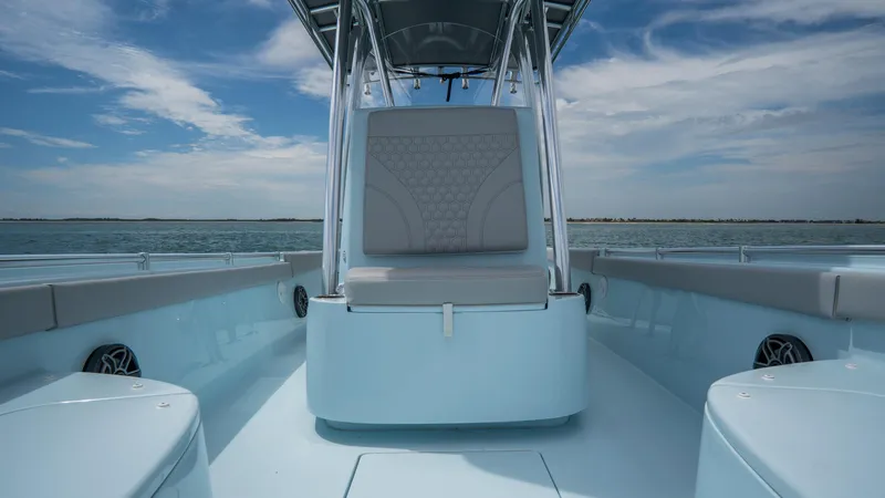 Slide: The Image of 2024 Contender 24 Sport boat interior with seating, on a calm sea under a blue sky. - 14