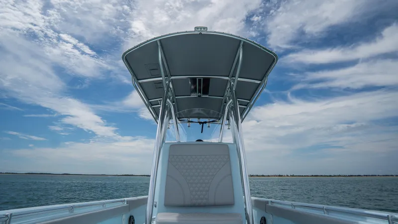 Slide: The Image of 2024 Contender 24 Sport boat on open water under a blue sky. - 16
