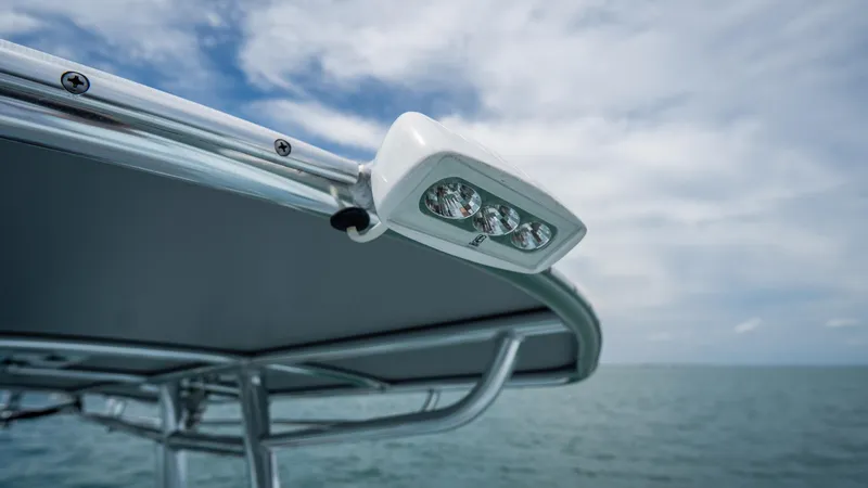 Slide: The Image of 2024 Contender 24 Sport boat with LED light, ocean backdrop, and cloudy sky. - 17