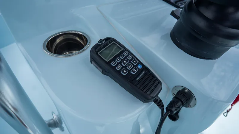 Slide: The Image of VHF radio on 2024 Contender 24 Sport boat console. - 24