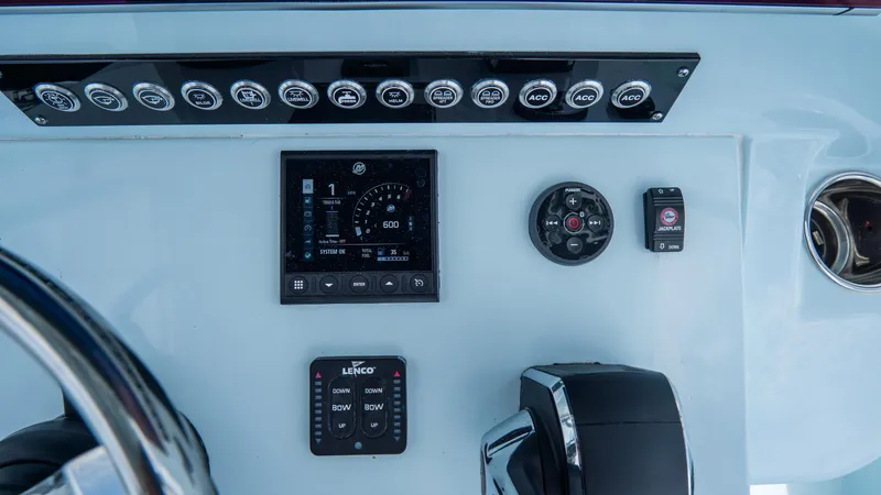 Slide: The Image of Dashboard of 2024 Contender 24 Sport boat with controls and gauges. - 26