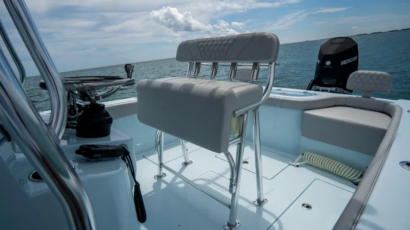 Slide: The Image of 2024 Contender 24 Sport boat interior with seating and ocean view. - 28