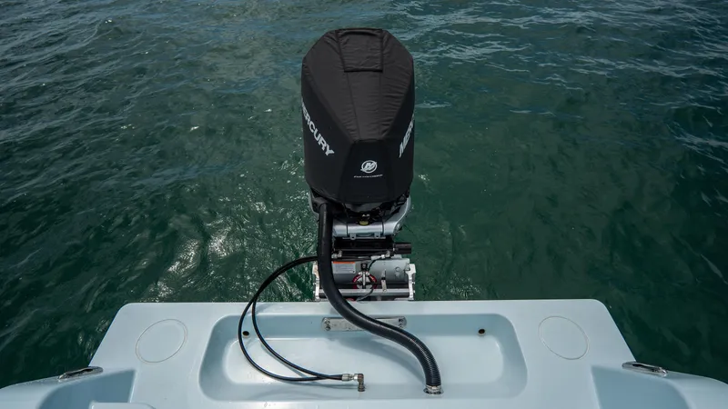 Slide: The Image of 2024 Contender 24 Sport boat with Mercury outboard motor on open water. - 32