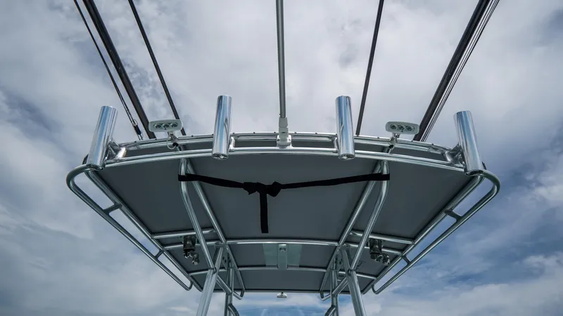 Slide: The Image of 2024 Contender 24 Sport boat's T-top against a cloudy sky. - 33