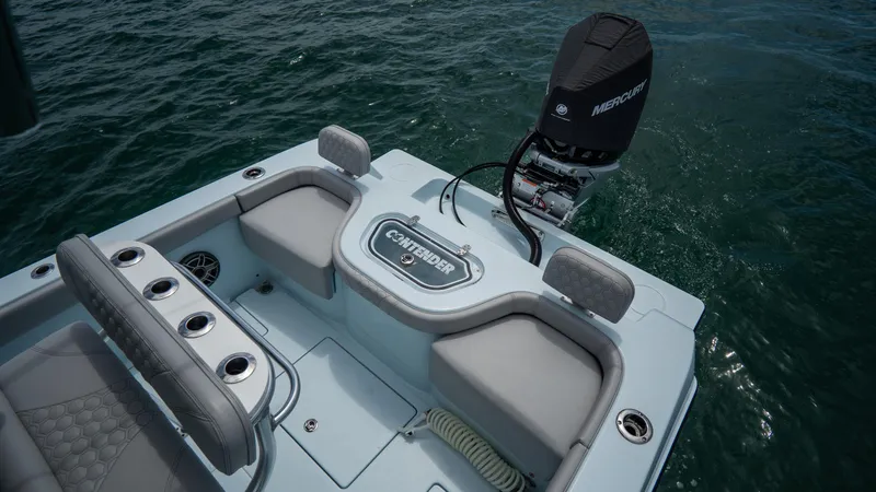 Slide: The Image of 2024 Contender 24 Sport boat with Mercury engine, featuring spacious seating and rod holders. - 35