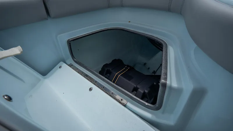 Slide: The Image of 2024 Contender 24 Sport boat storage compartment with visible interior. - 36
