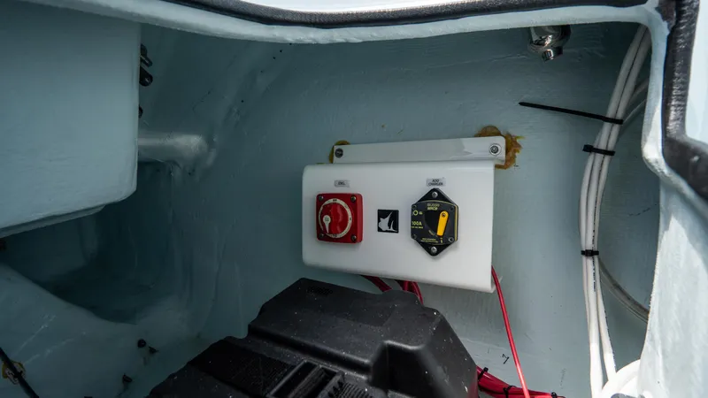 Slide: The Image of 2024 Contender 24 Sport boat electrical panel with switches and wiring. - 38