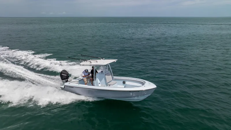Slide: The Image of 2024 Contender 24 Sport boat cruising on open ocean waters. - 44