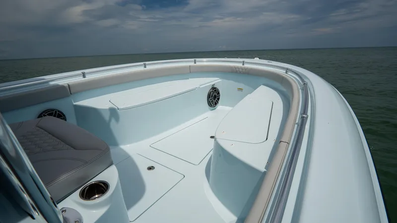Slide: The Image of 2024 Contender 24 Sport boat interior with seating, cup holders, and ocean view. - 5