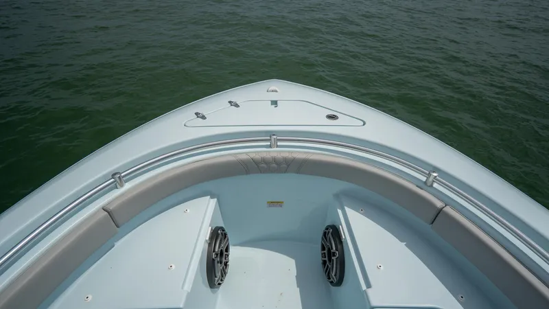 Slide: The Image of 2024 Contender 24 Sport boat bow on water, showcasing sleek design and spacious seating. - 6