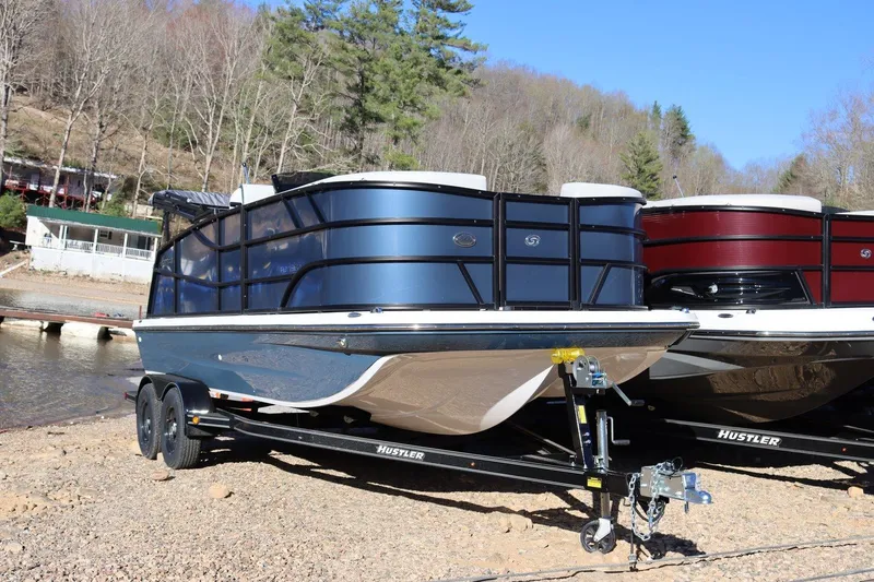 The Image of 2024 Hurricane FD 1960RE3 OB boat on trailer by lakeside, surrounded by trees. - 1
