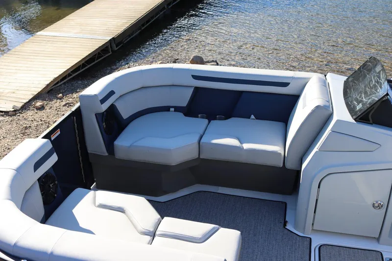 Slide: The Image of 2024 Hurricane FD 1960RE3 OB boat interior with plush seating near a dock. - 5