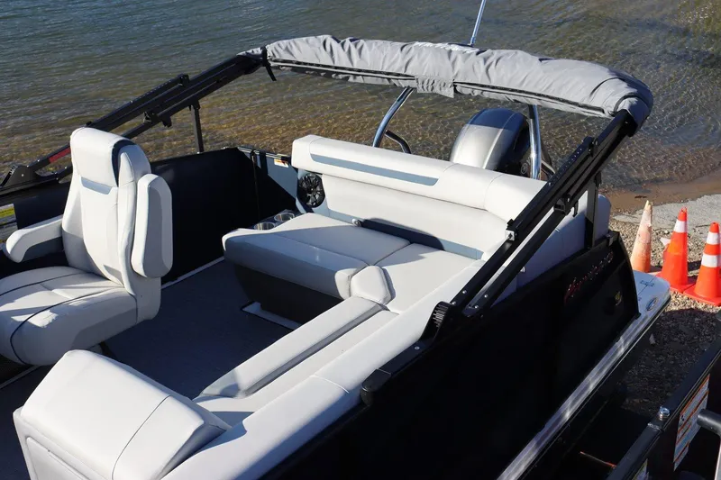 Slide: The Image of 2024 Hurricane FD 1960RE3 OB boat interior with seating, near water. - 6