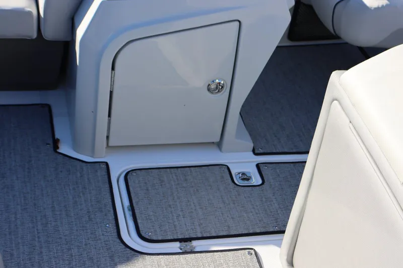 Slide: The Image of 2024 Hurricane FD 1960RE3 OB boat interior with storage compartments and gray flooring. - 7