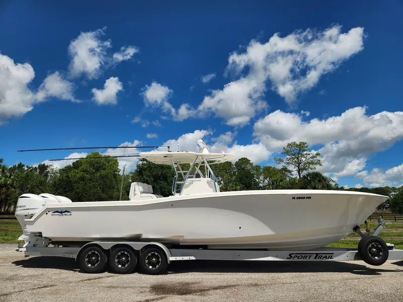 Slide: The Image of 2013 Invincible 36 Open Fisherman boat on trailer under blue sky. - 0