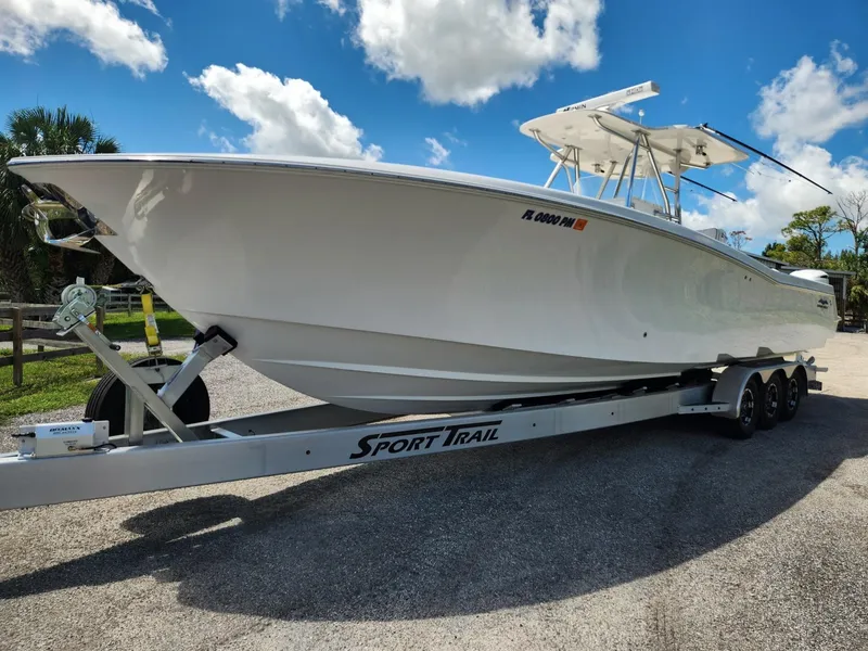 Slide: The Image of 2013 Invincible 36 Open Fisherman boat on Sport Trail trailer under blue sky. - 1