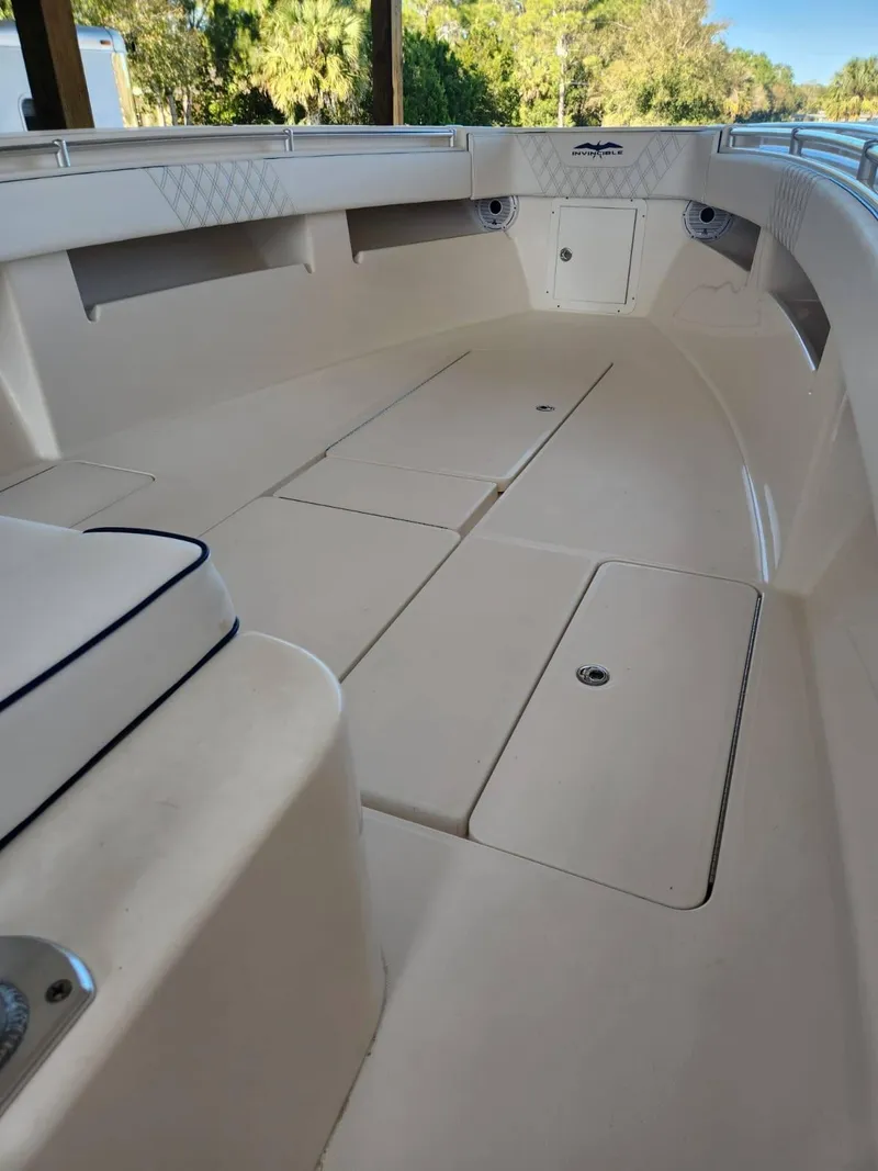 Slide: The Image of 2013 Invincible 36 Open Fisherman boat interior with spacious deck and storage compartments. - 10