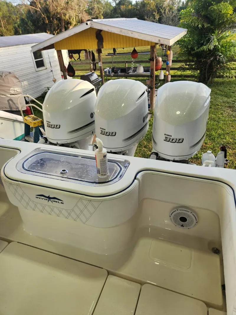 Slide: The Image of 2013 Invincible 36 Open Fisherman with triple 300 horsepower engines, docked outdoors. - 11