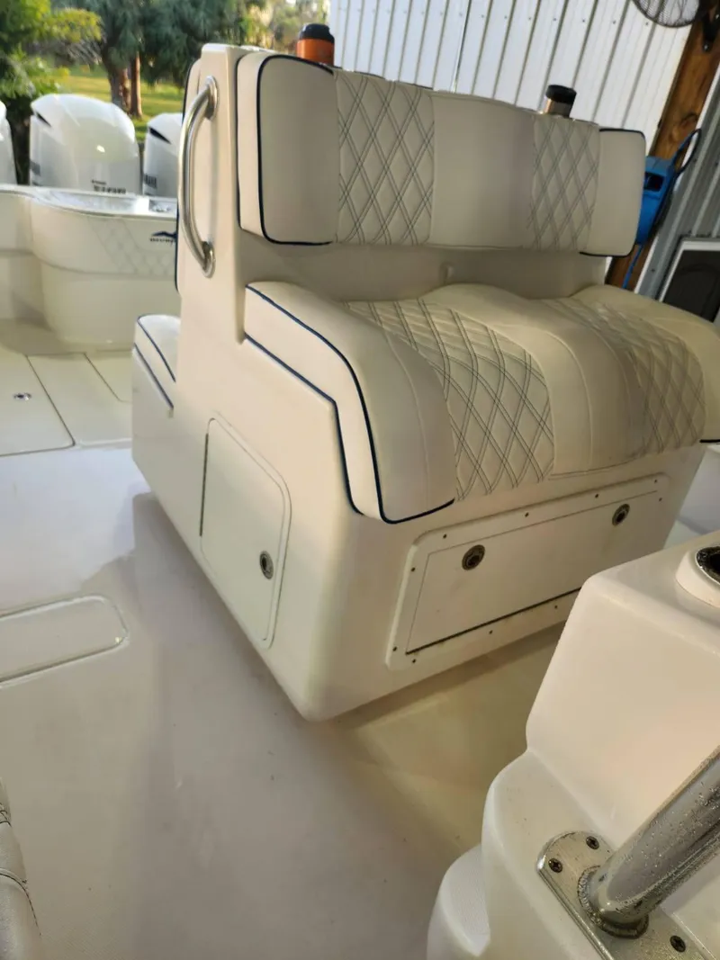 Slide: The Image of 2013 Invincible 36 Open Fisherman boat interior with cushioned seating and storage compartments. - 17