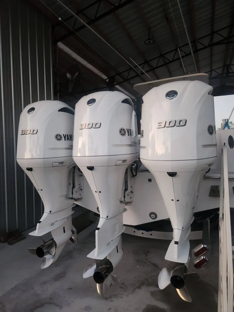 Slide: The Image of Triple Yamaha 300 engines on a 2013 Invincible 36 Open Fisherman boat. - 27