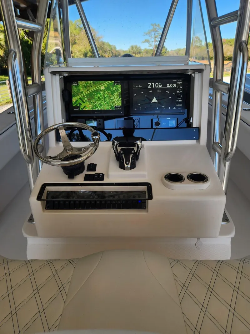 Slide: The Image of 2013 Invincible 36 Open Fisherman helm with navigation screens and steering wheel. - 29