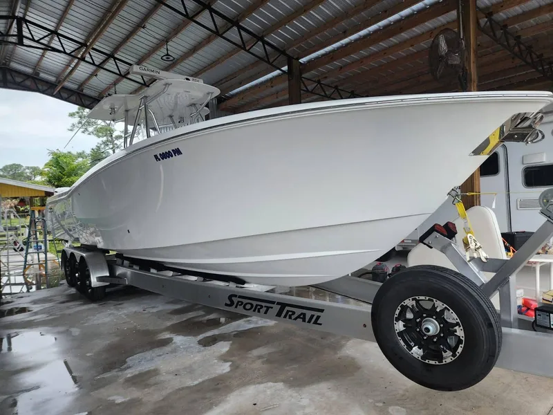 Slide: The Image of 2013 Invincible 36 Open Fisherman boat on Sport Trail trailer in covered storage. - 3