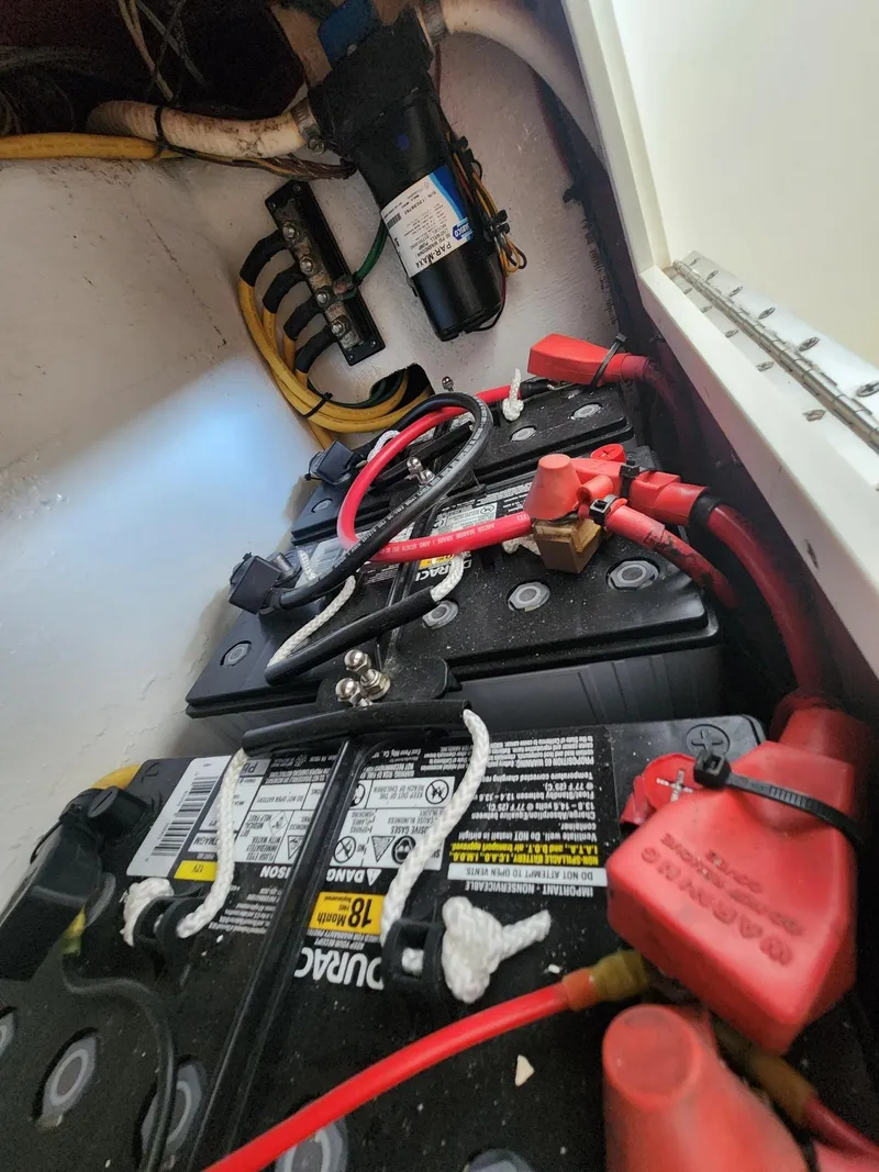 Slide: The Image of Battery compartment of 2013 Invincible 36 Open Fisherman boat with wiring and connections. - 30