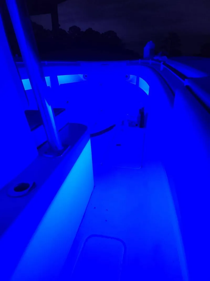Slide: The Image of 2013 Invincible 36 Open Fisherman boat interior illuminated with blue LED lights. - 32