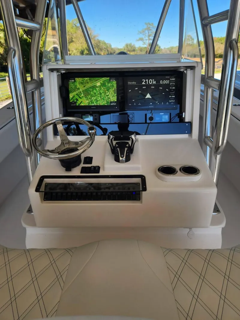 Slide: The Image of 2013 Invincible 36 Open Fisherman helm with modern navigation and control systems. - 33