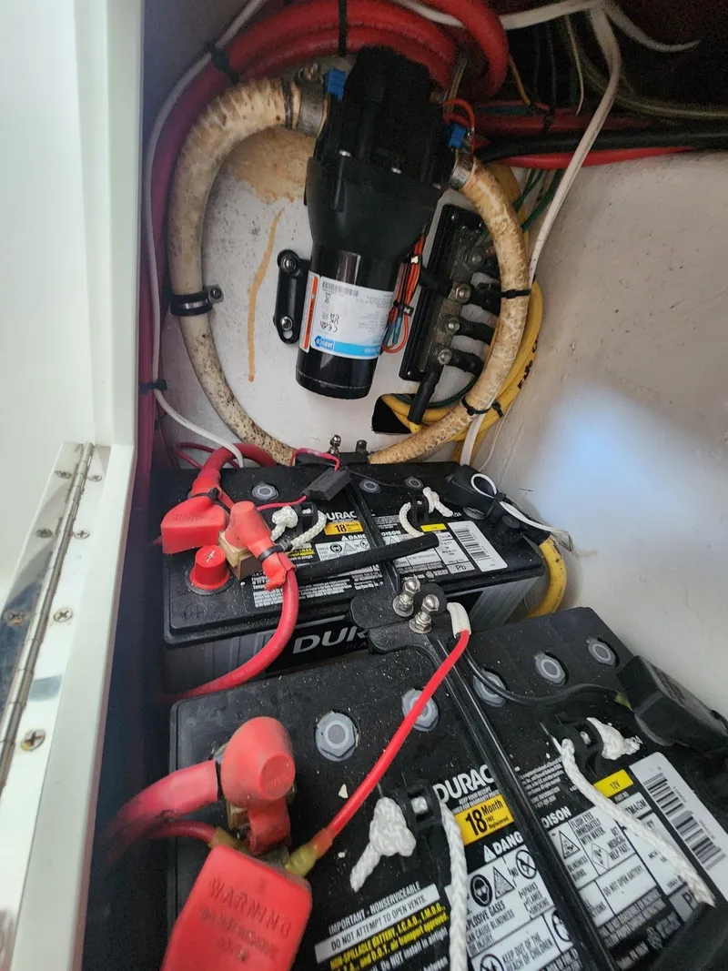Slide: The Image of Battery compartment of 2013 Invincible 36 Open Fisherman with wiring and components. - 38