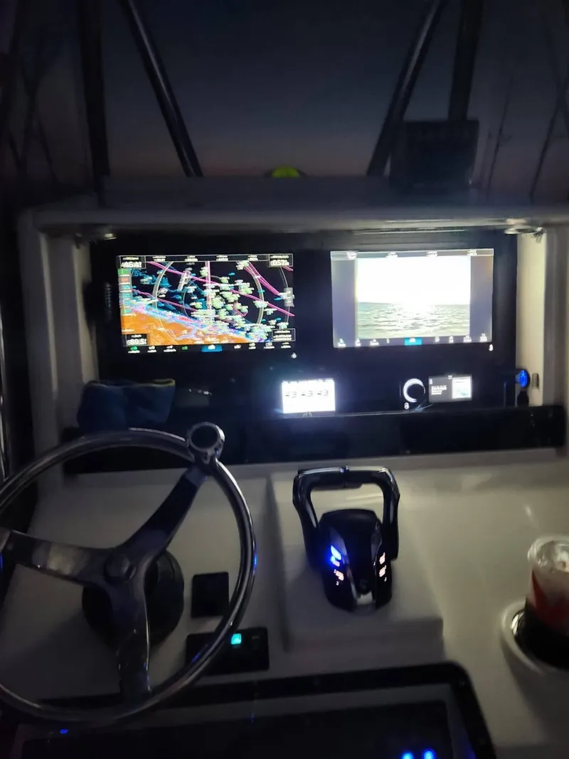Slide: The Image of Control panel of a 2013 Invincible 36 Open Fisherman boat at night. - 4